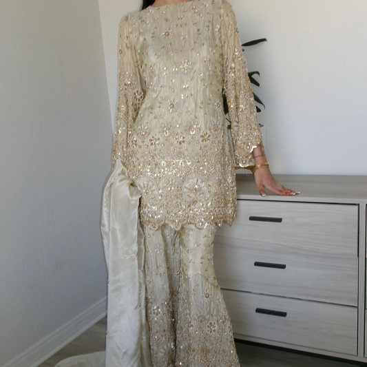 Flared plazzo Set and pearl work paired with a scalloped edge dupatta.